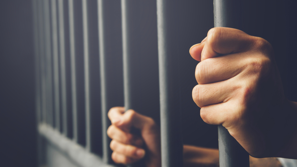 Hands on Prison Bars