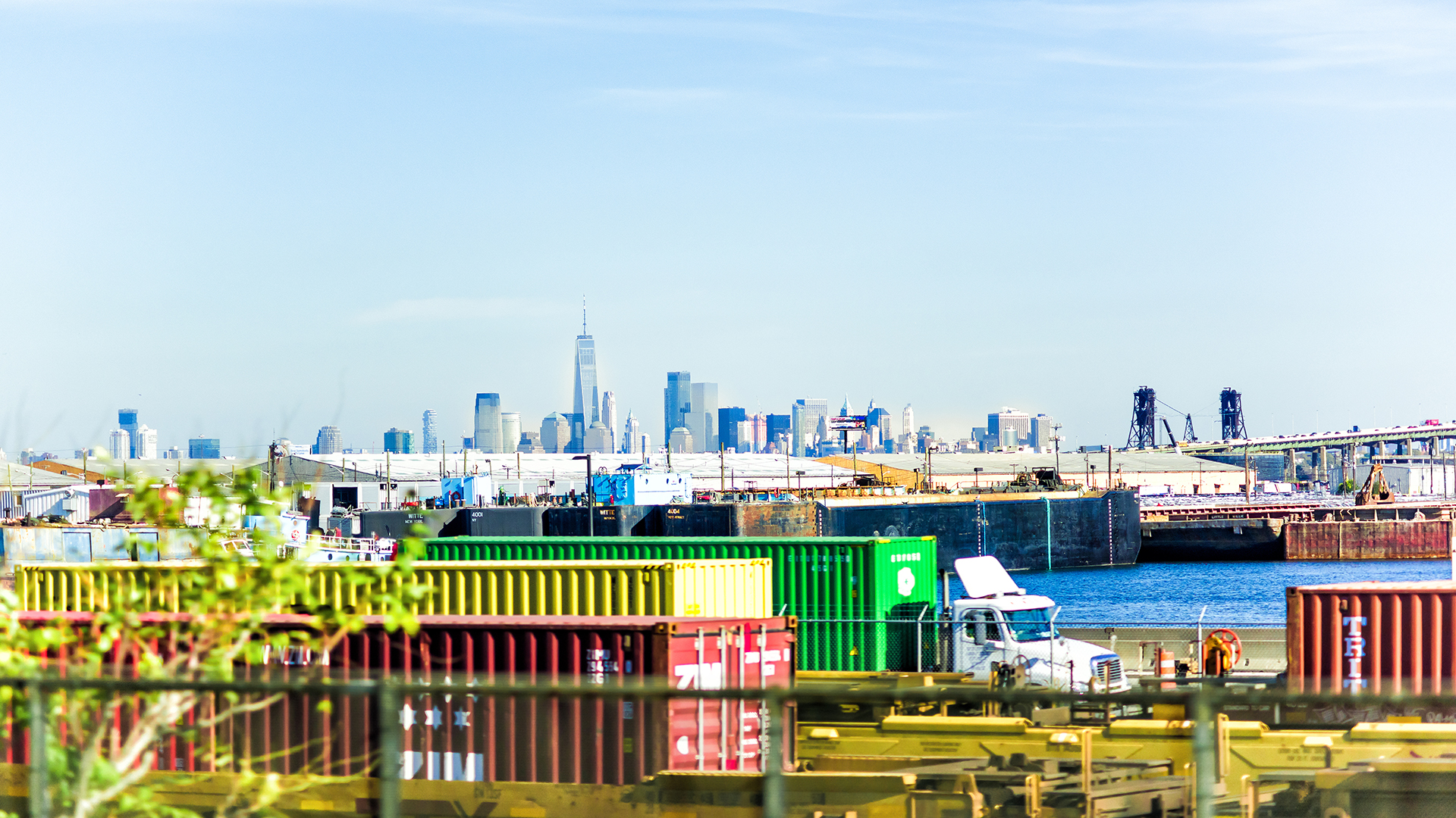 Industrial site in New Jersey with railcars, freight car management services, rail industry, port, NY skyline
