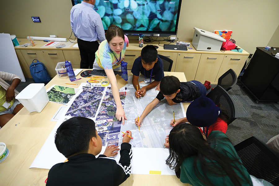 Bloustein student Zoe McGowan BS UPD ‘25 assists New Brunswick students with their mapping techniques at the 2024 Creative Cities Design Camp.