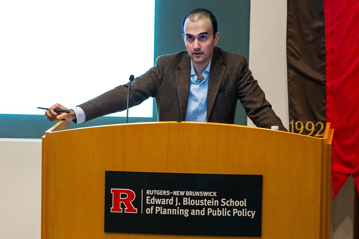 Bloustein alumnus Dan Dominguez PP, AICP, MCRP ’14 answers audience question at the podium in the Bloustein School's Civic Square Building presenting the 2026 Meck Memorial Lecture, "New Brunswick: The Last Seven Years and the Next Seven Years."